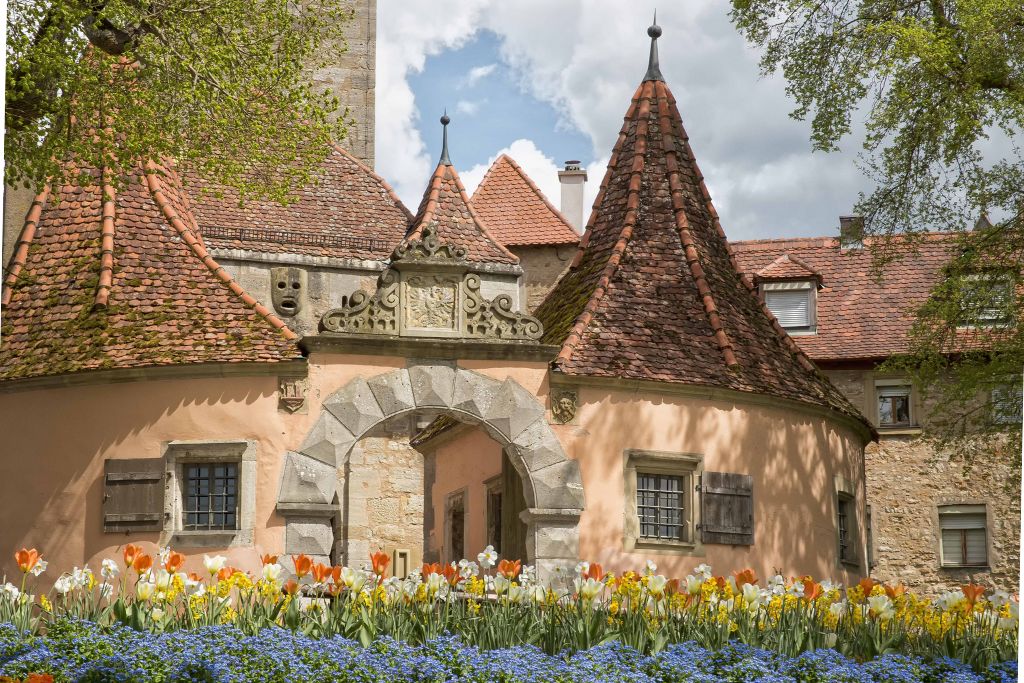rothenburg castle gate with tulips in front