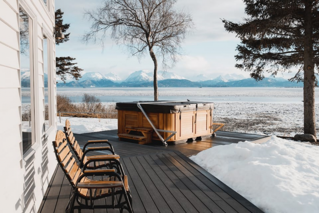 A Hot Tub Airbnb in Homer, Alaska Overlooking Snowcapped Mountains.