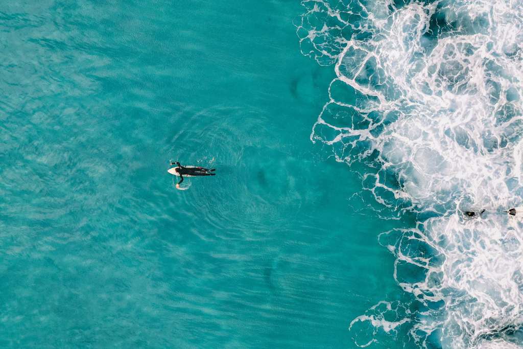 surfer immersing into the sea