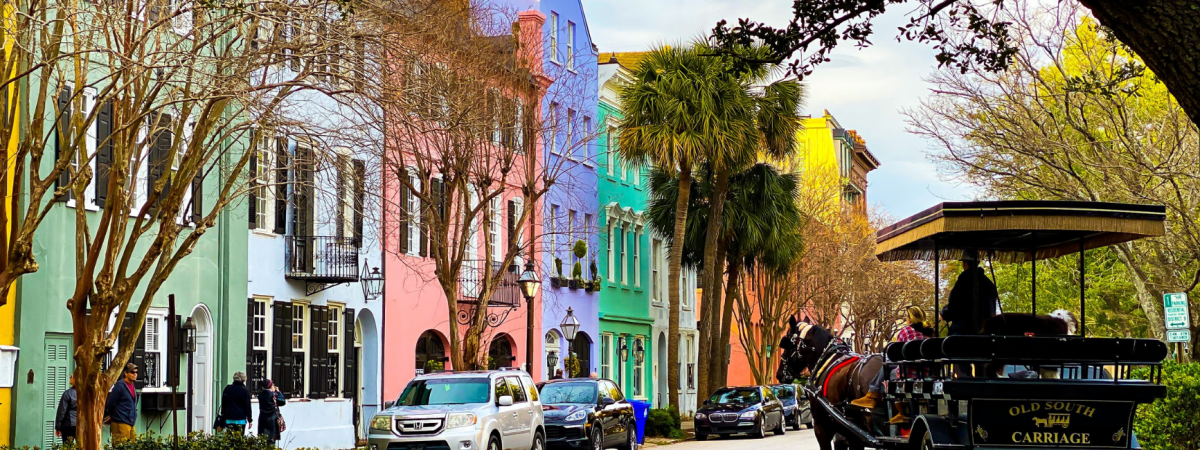colorful homes in Charleston with a house and carriage near by