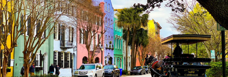 colorful homes in Charleston with a house and carriage near by