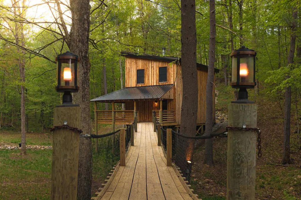 Two-Story Cabin With a Wooden Footbridge in the Adirondacks.