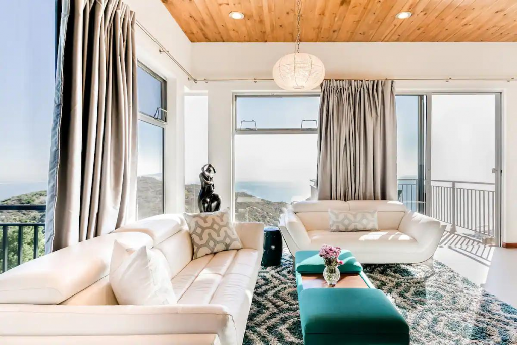 A Bright Airbnb With Many Windows Set High Above Surfrider Beach in California. 