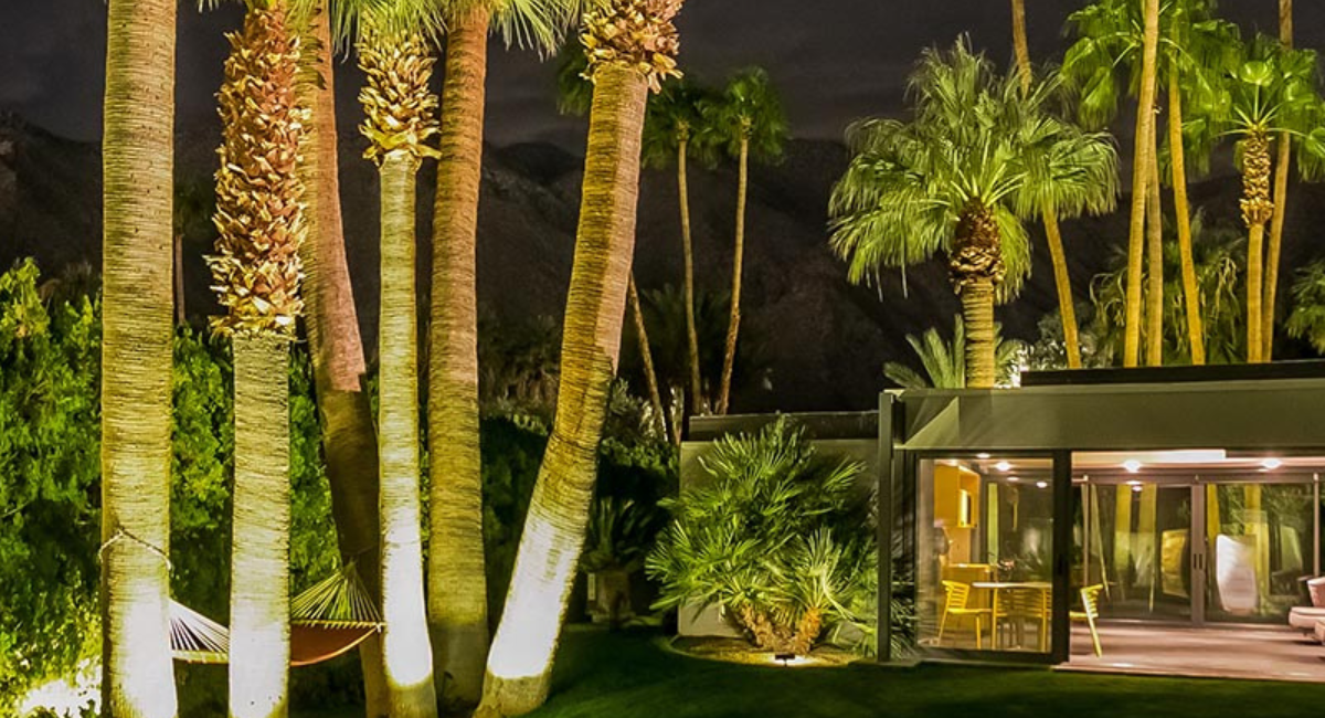 villa in California at dusk surrounded by palm trees