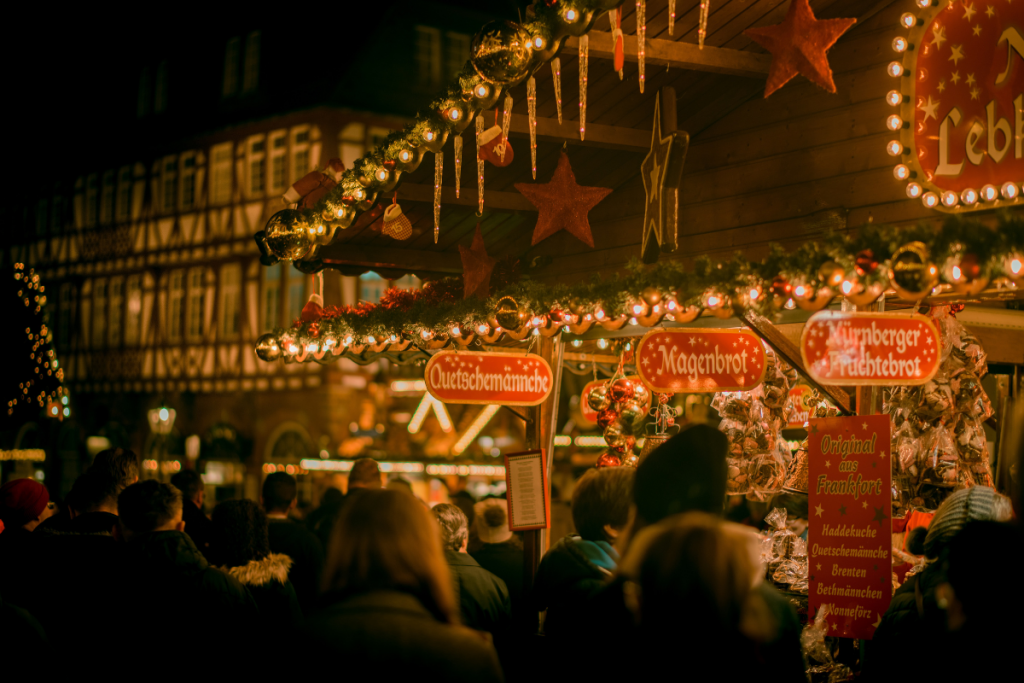 Shoppers at the Nuremberg Christmas Market Look At Handcrafted Ornaments, Toys, and Decor.