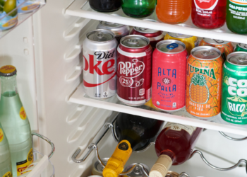 mini bar filled with water, soda and wine with colorful labels