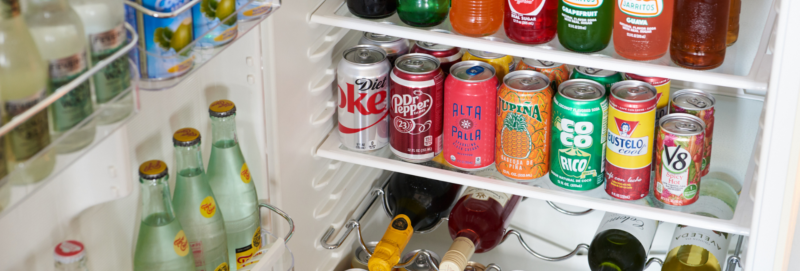mini bar filled with water, soda and wine with colorful labels