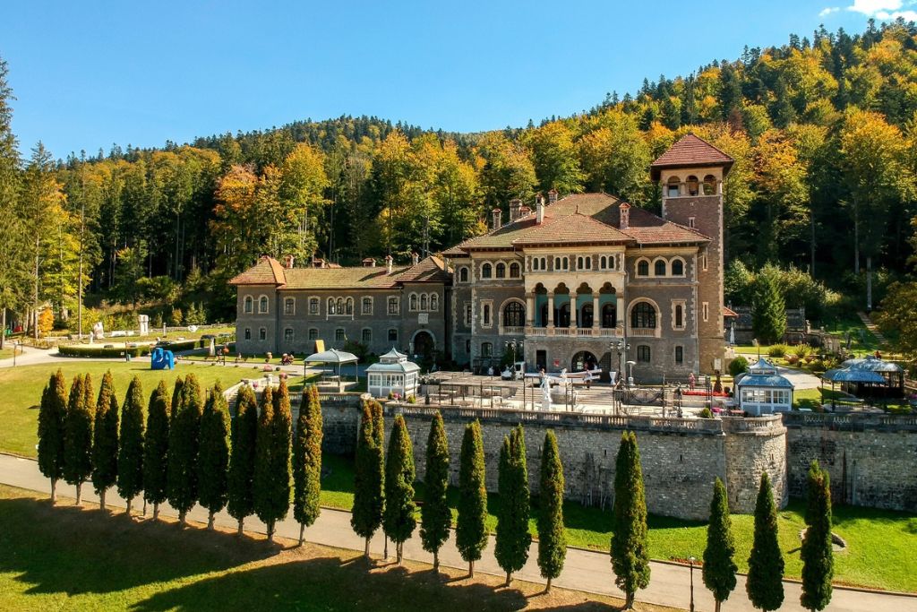 Romania's Cantacuzino Castle surrounded by fall foliage.