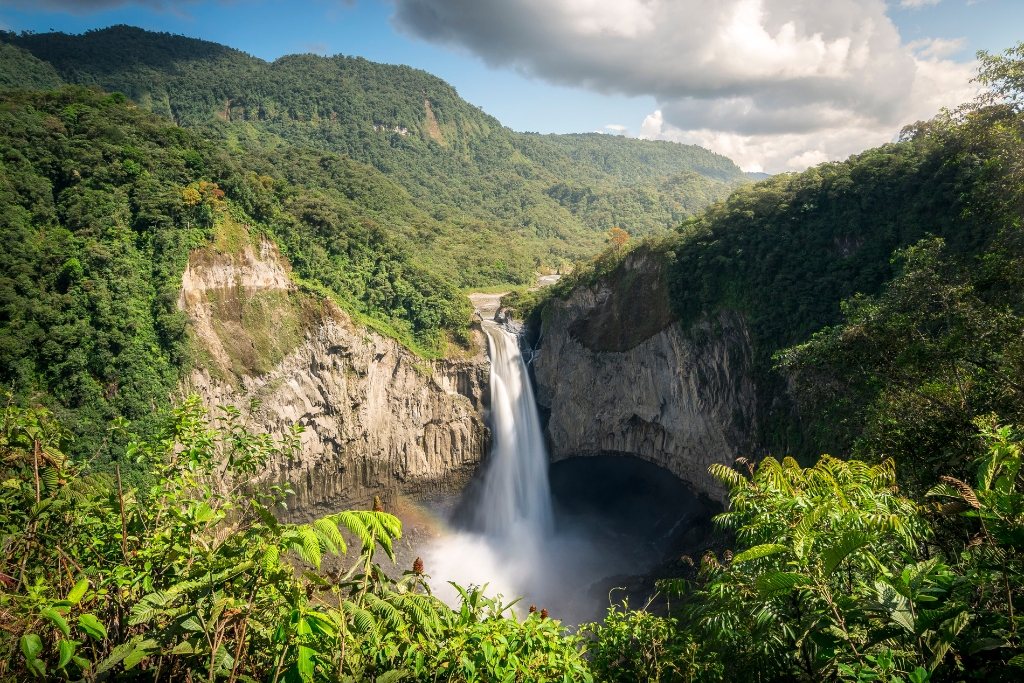 green mountains and blue sky and waterfall in ecuador