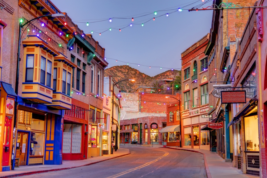 neon lights and charming buildings in front of a mountain backdrop in bisbee