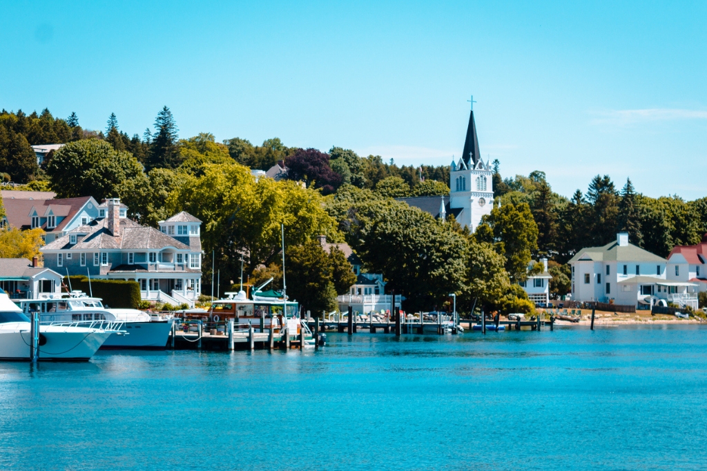 blue lake in front of the small town and docks and yachts