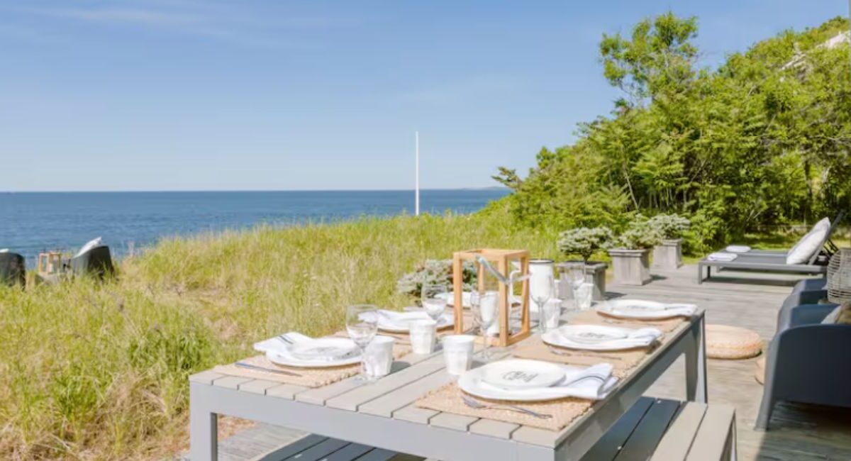 outdoor dining table at beachfront cottage overlooking ocean