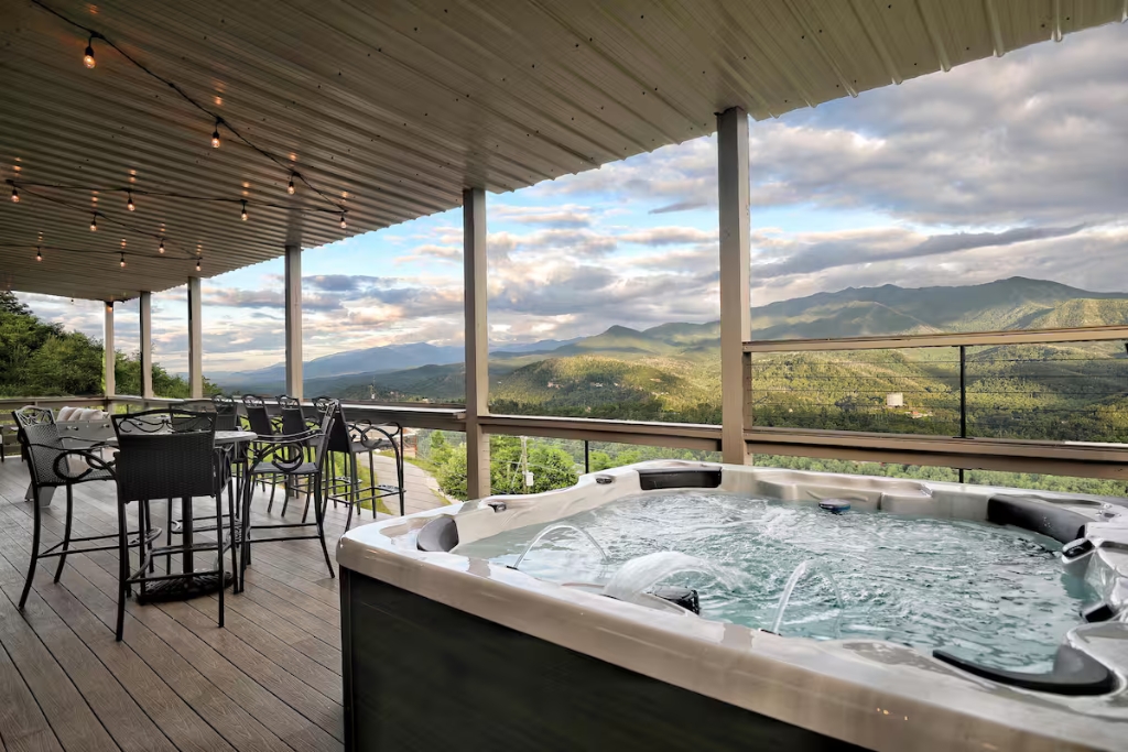 Hot tub on a balcony with twinkly lights in tennessee looking out on a mountain view