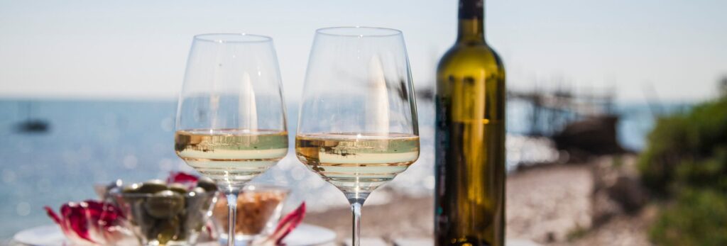 white wine glasses on beachside table