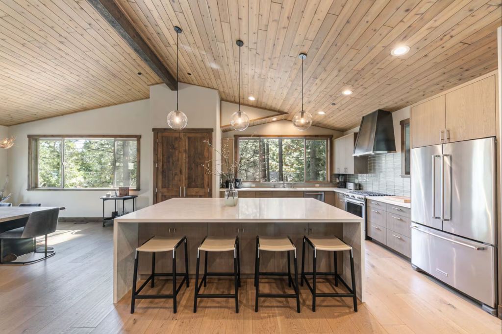 natural wood kitchen with granite island and large windows in lake tahoe
