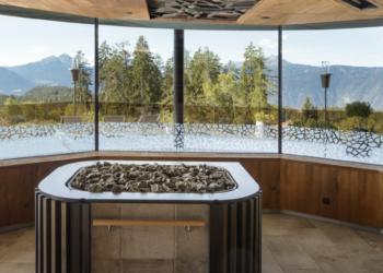 sauna room at hotel chalet mirabell facing trees and mountains