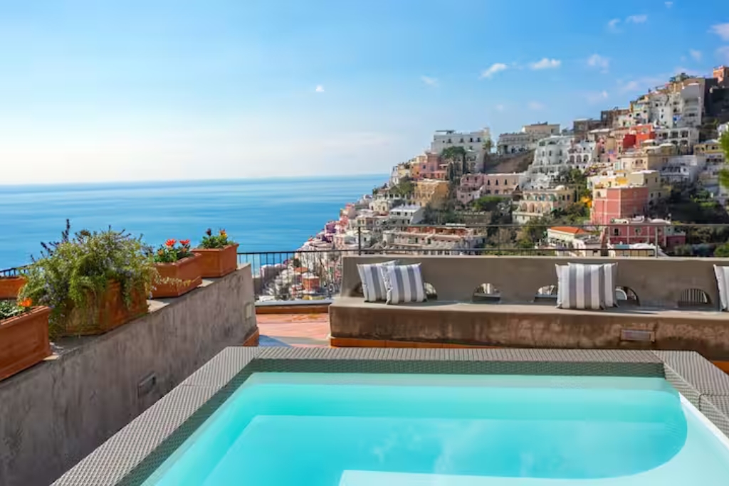 poolon a balcony in the amalfi coast with a view of the cliff and modern cement benches 
