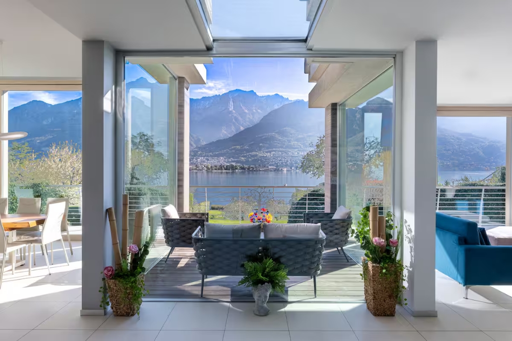sunroom looking out onto lake como with a seating arrangement facing the view