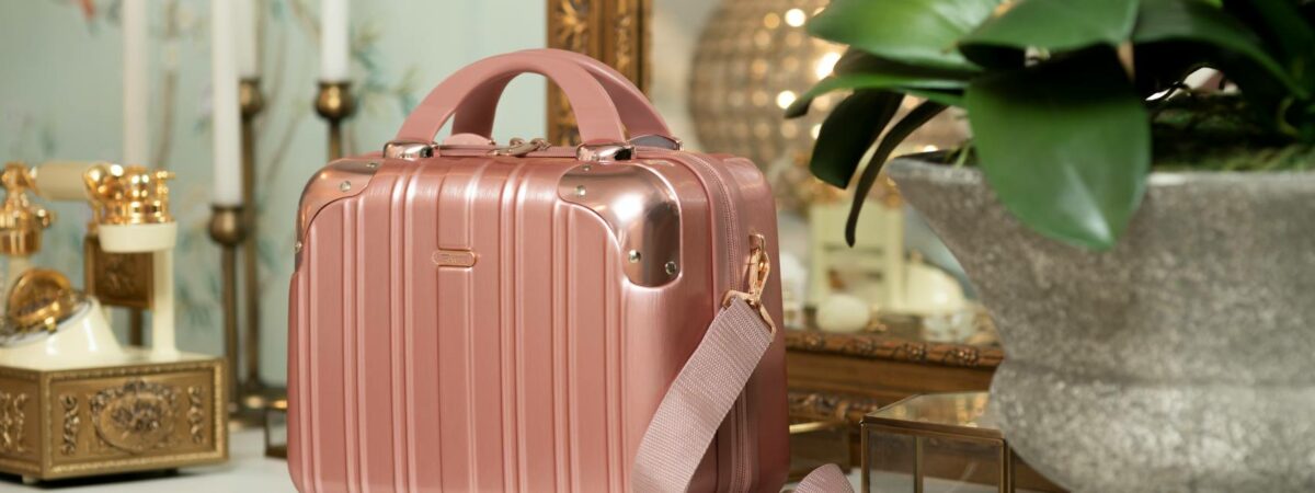 a pink suitcase sitting on a dresser
