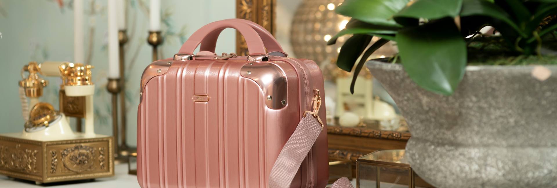 a pink suitcase sitting on a dresser