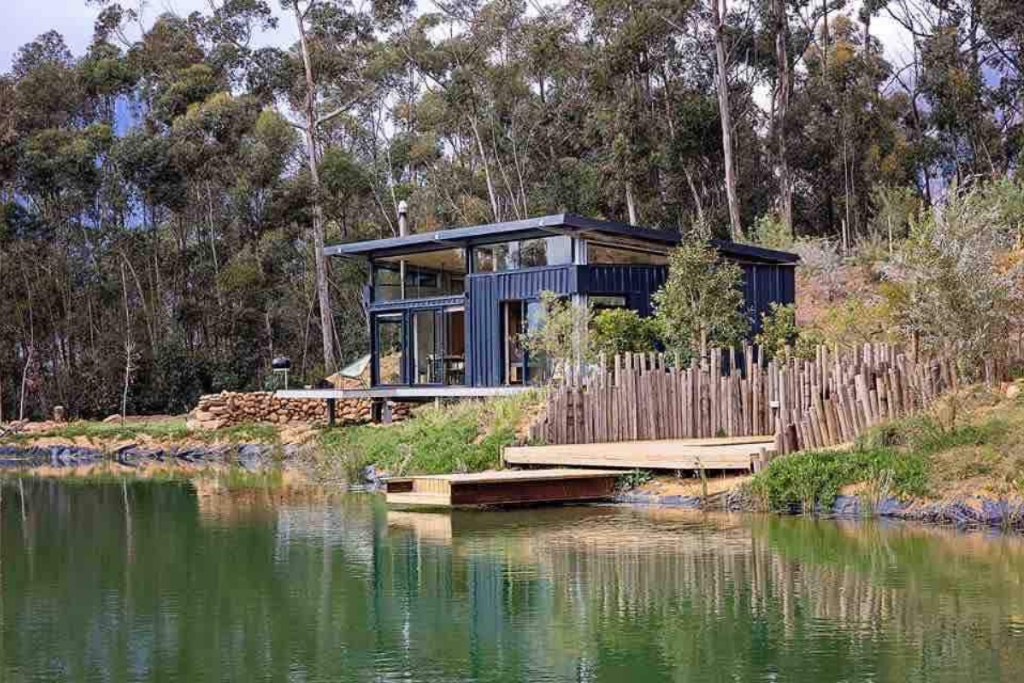 black cabin home in south africa on a lake 