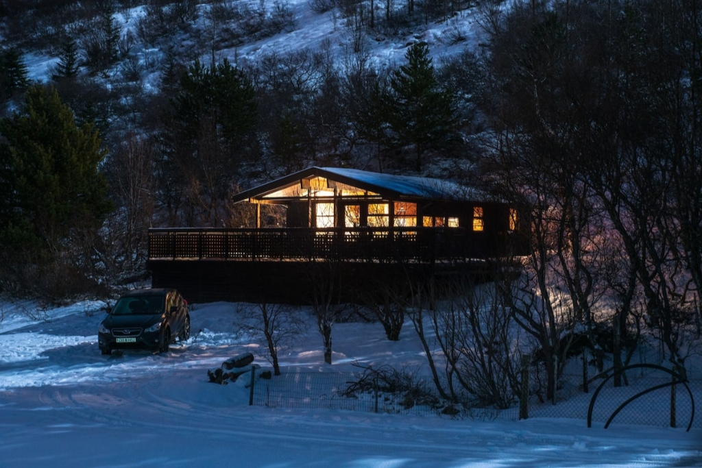 cabin in the blue lagoon surrounded by snow at night