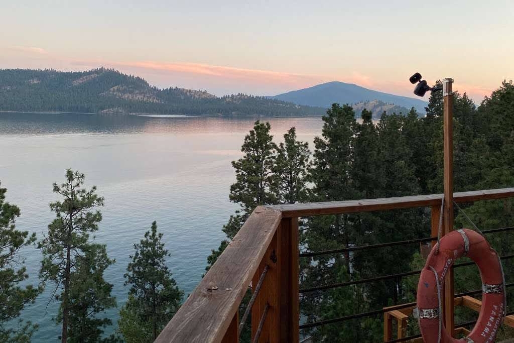 view of the mountains and a beautiful sunset over a lake in whitefish montana