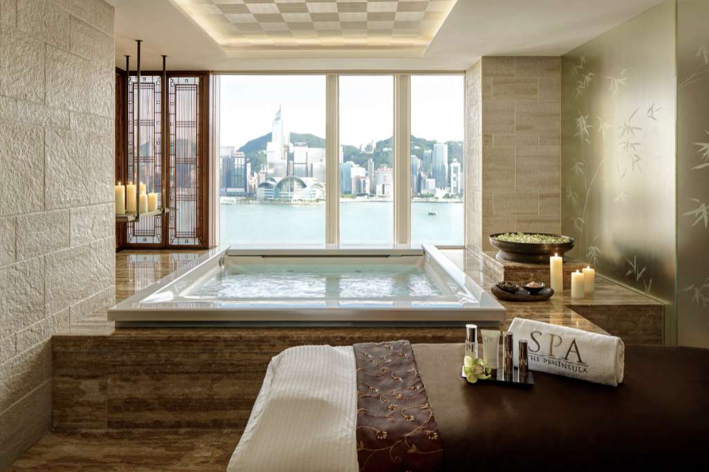 spa suite and tub with a view at the peninsula hong kong