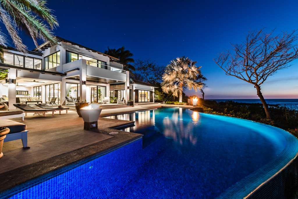 infinity pool after sunset at the point luxury villa, costa rica