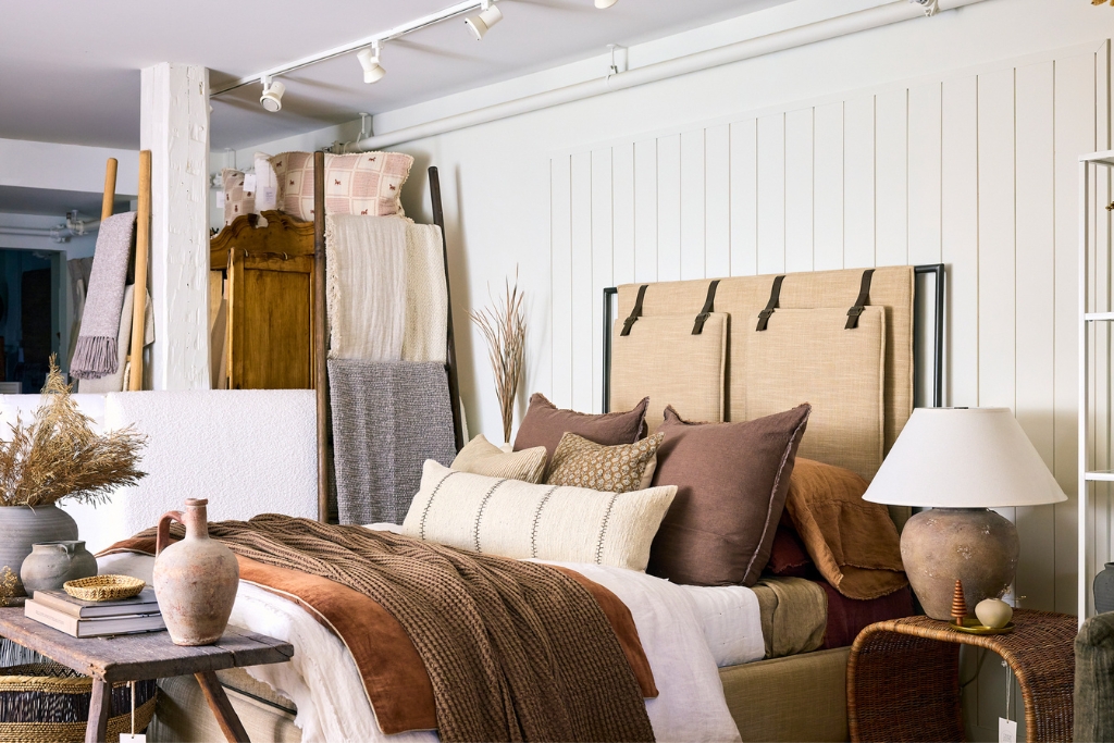 beige and brown bed with throw pillows made for show in farm home co