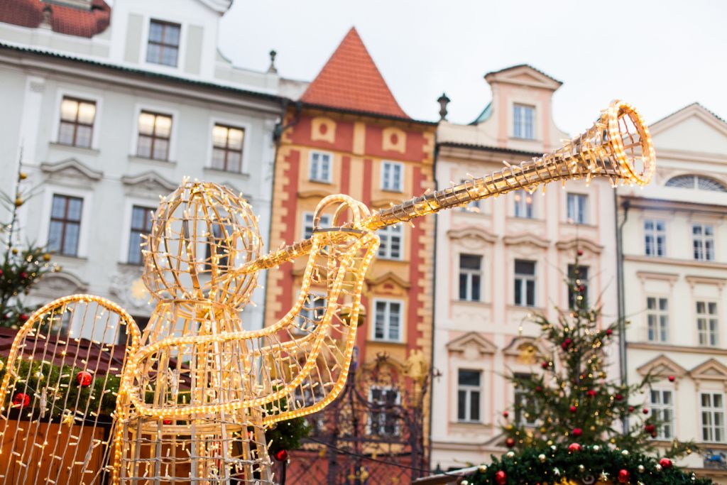 A Christmas angel decoration in front of Pragues beautiful architecture 