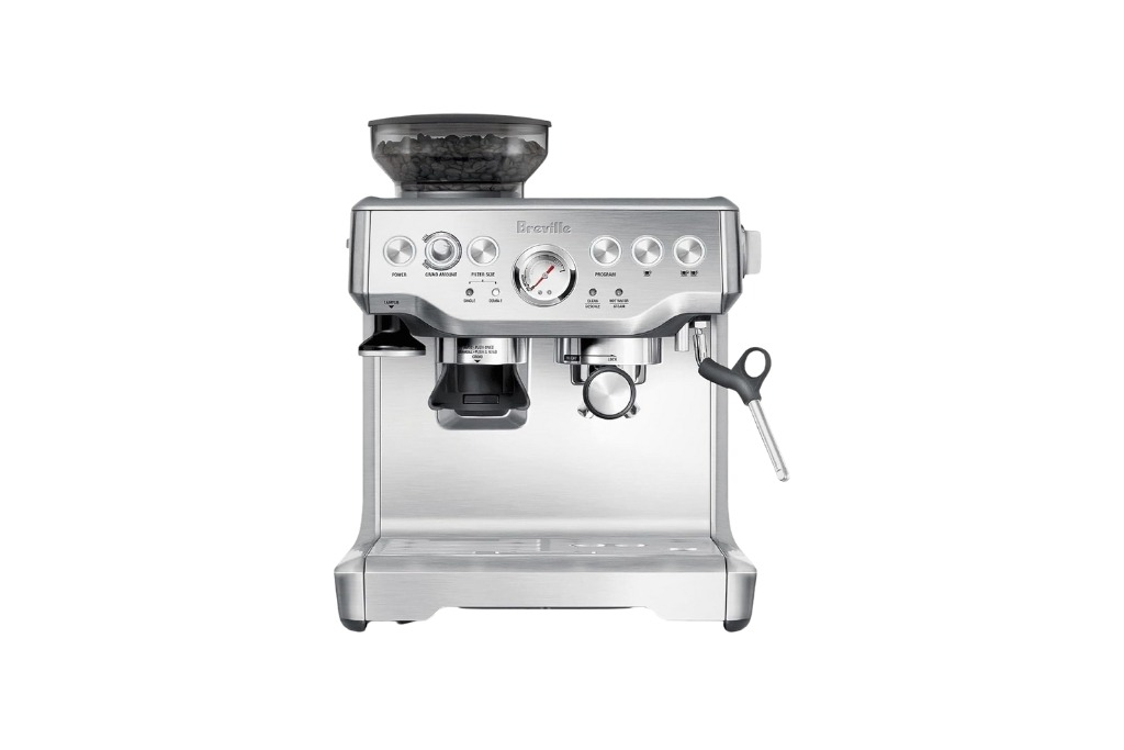breville silver espressp machine with black hardware and coffee beans in it