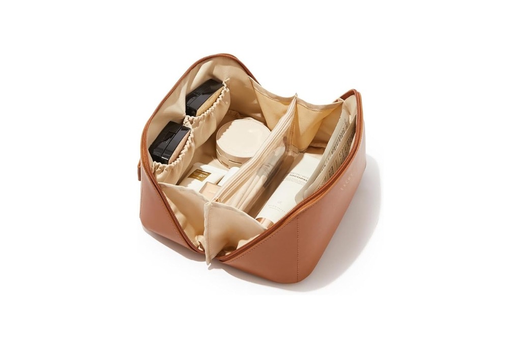 brown opened travel makeup bag with products organized inside