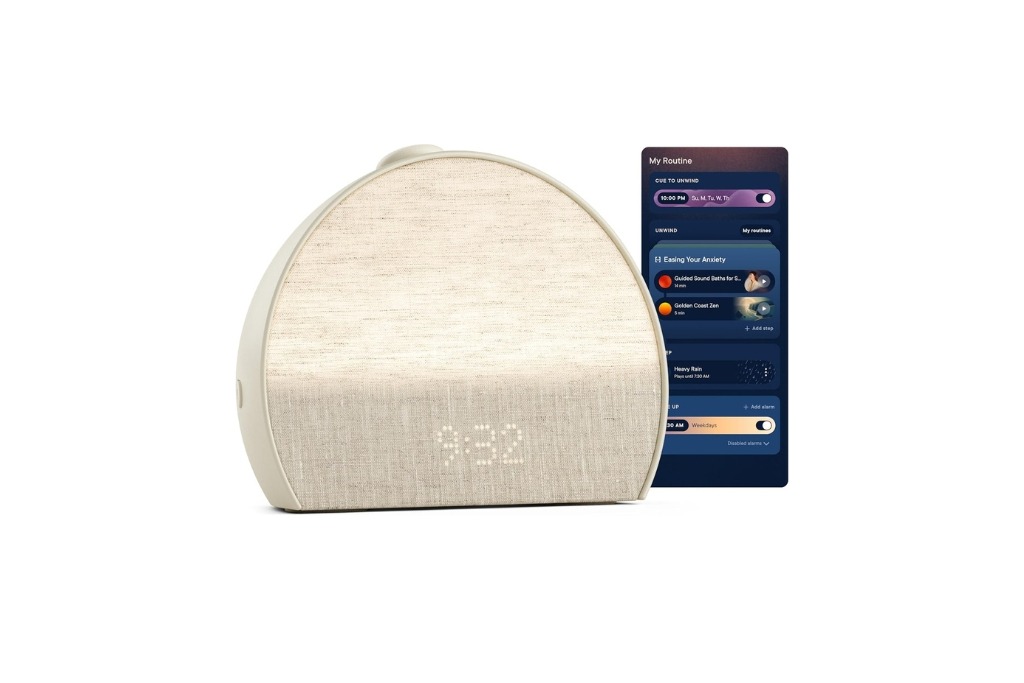 gold hatch alarm clock in the shape of a semi circle with the time in front and a phone. with controls next to it