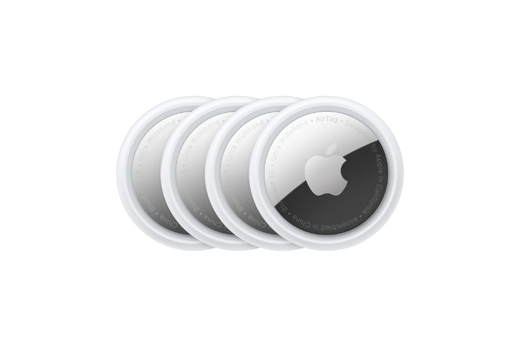 four circular and white and reflective apple airtags