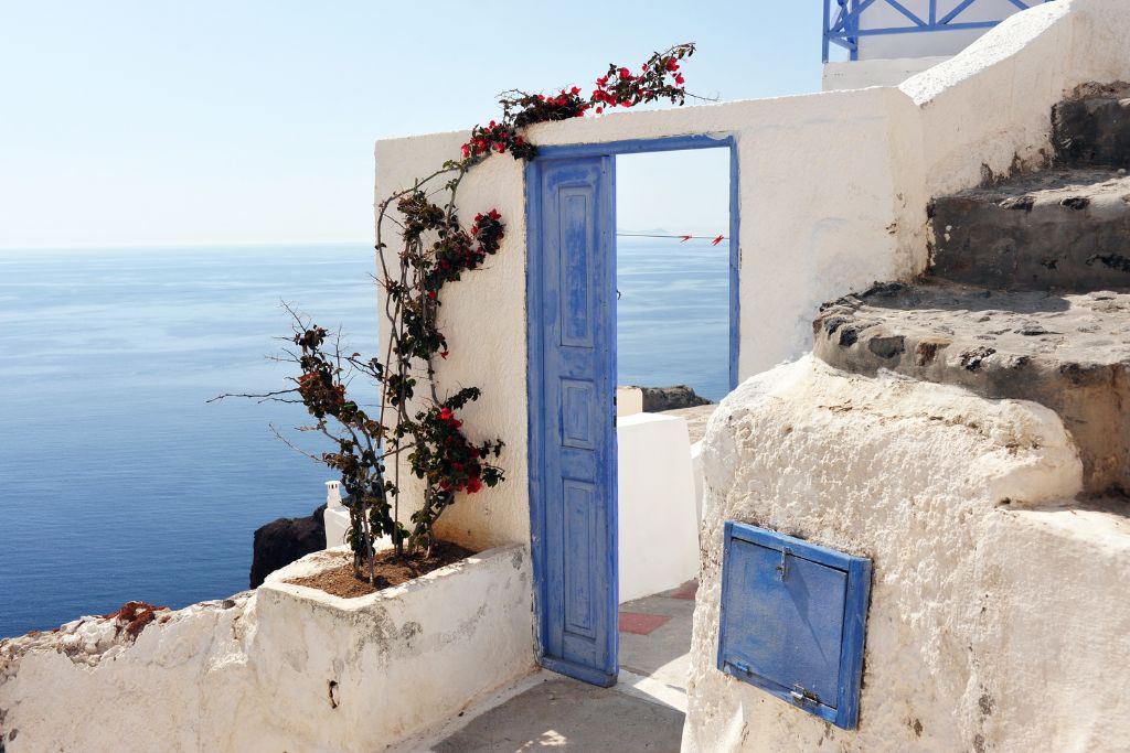 blue door near the ocean in greece
