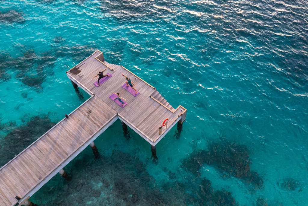 overwater sunrise yoga, kagi maldives