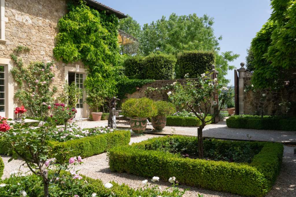 formal courtyard and gardens at borgo santo pietro in tuscany