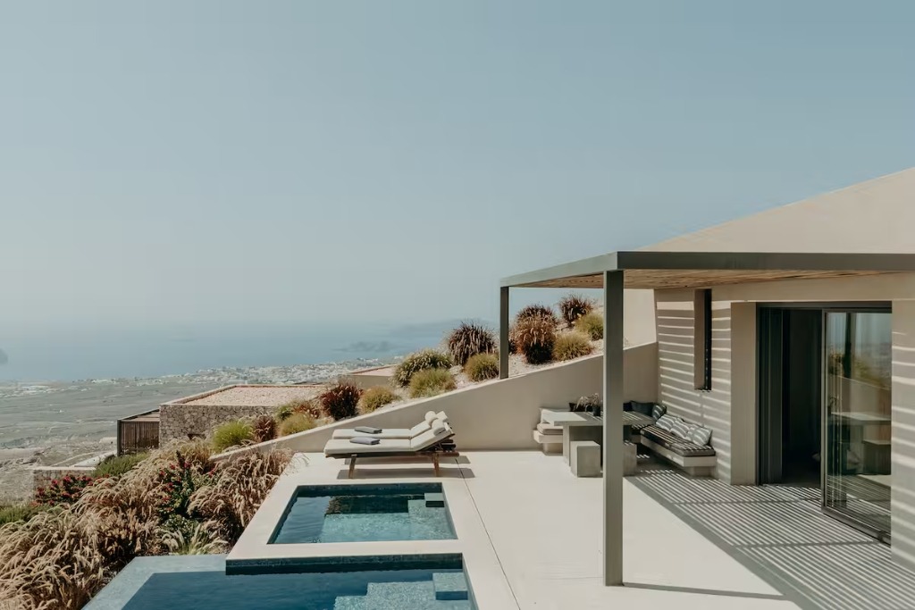 terrace of a home in greece with a view of the sky and an infinity pool on the edge