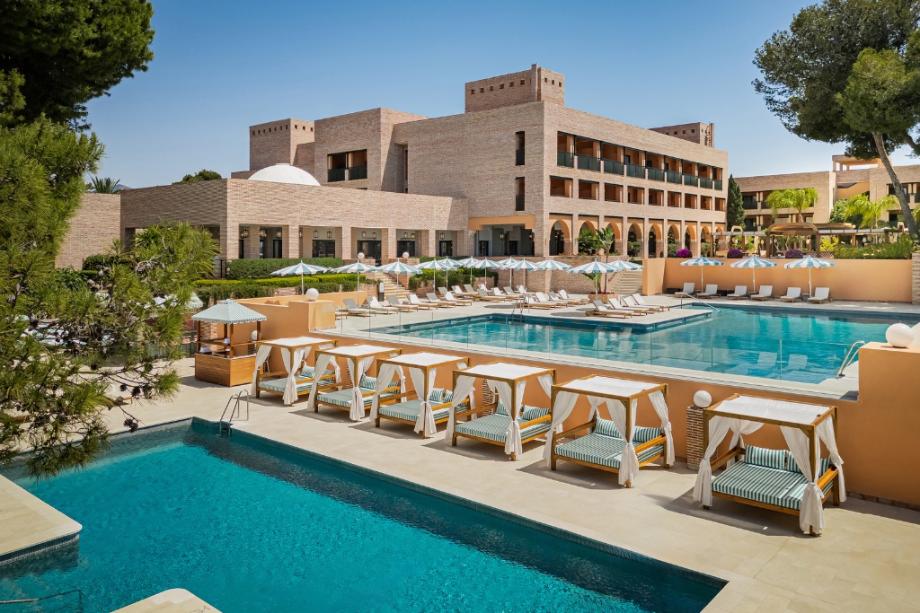 pool with lounge chairs at gran marbella resort and beach club