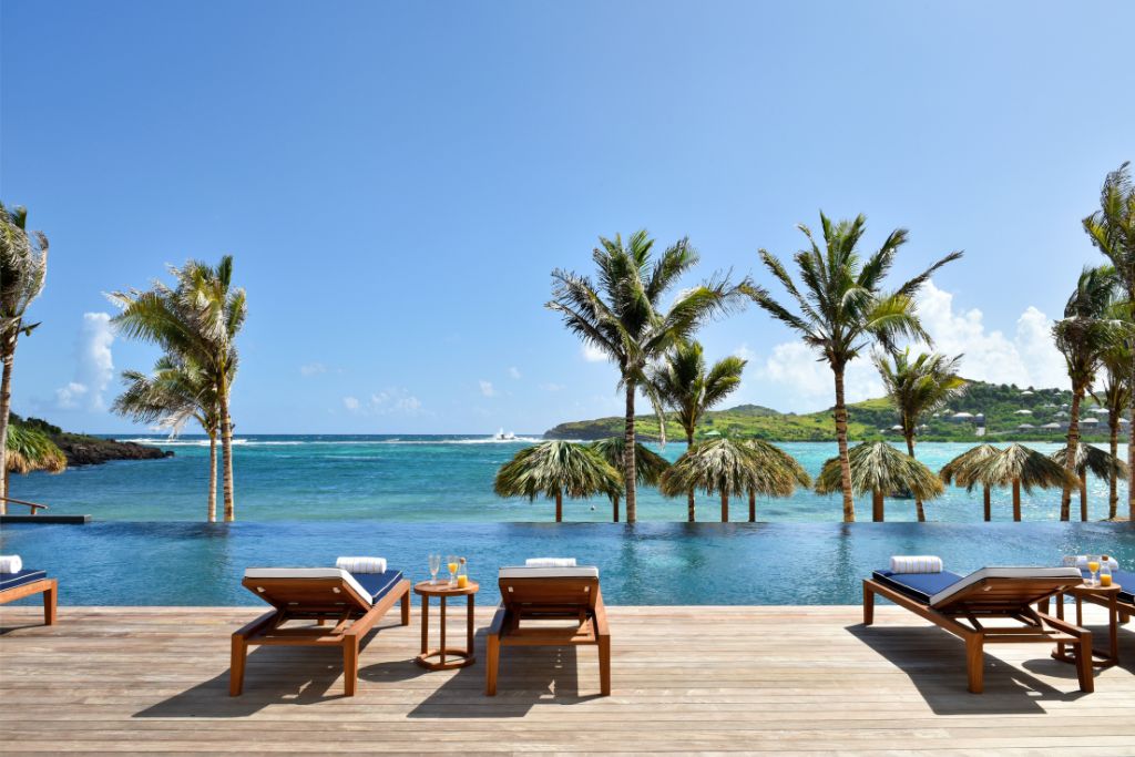 lounge chairs by the infinity pool at rosewood la guanahani in st barth