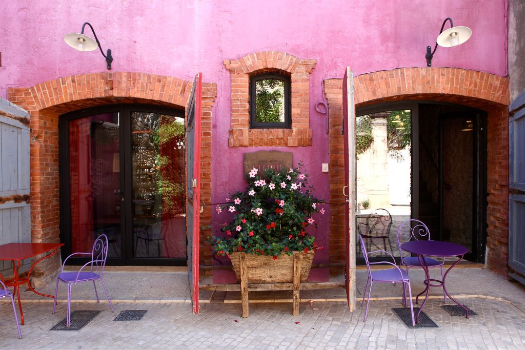 pink exterior of castigno in occitanie, france