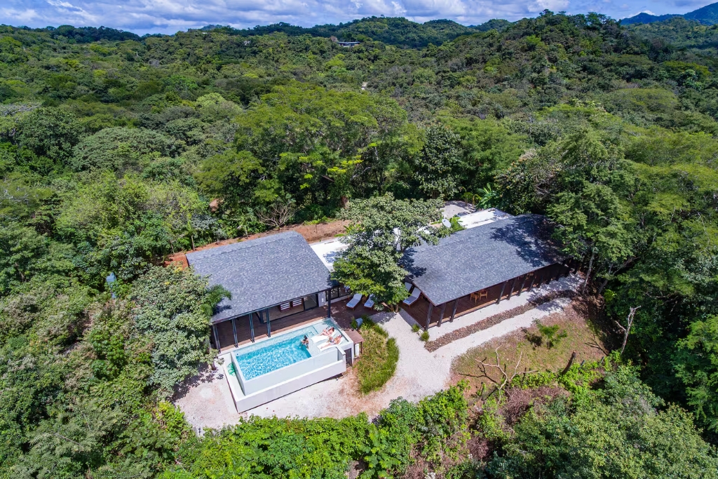 costa rica airbnb exterior and pool surrounded by lush greenery 
