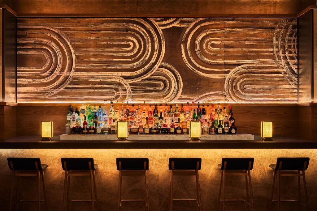 bar pendry at pendry manhattan west with a high top bar and dim lighting