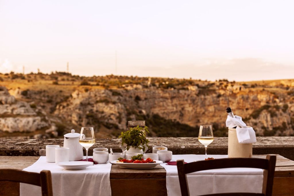 sextantio le grotte della civita table for two near vineyard in abruzzo italy