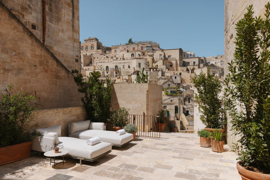 vetera matera hotel in italy lounge chairs on courtyard overlooking city