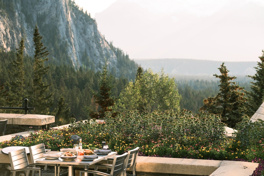 patio view of mountains and flowers at historic hotel fairmont banff springs
