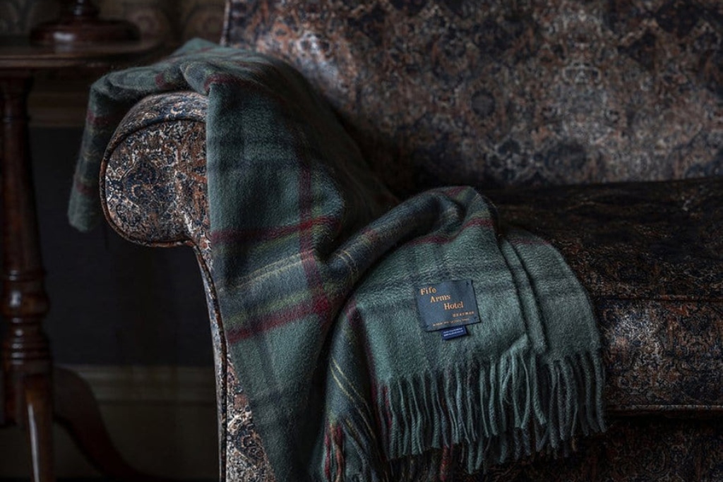 fife and arms tartan blanket laying on chair
