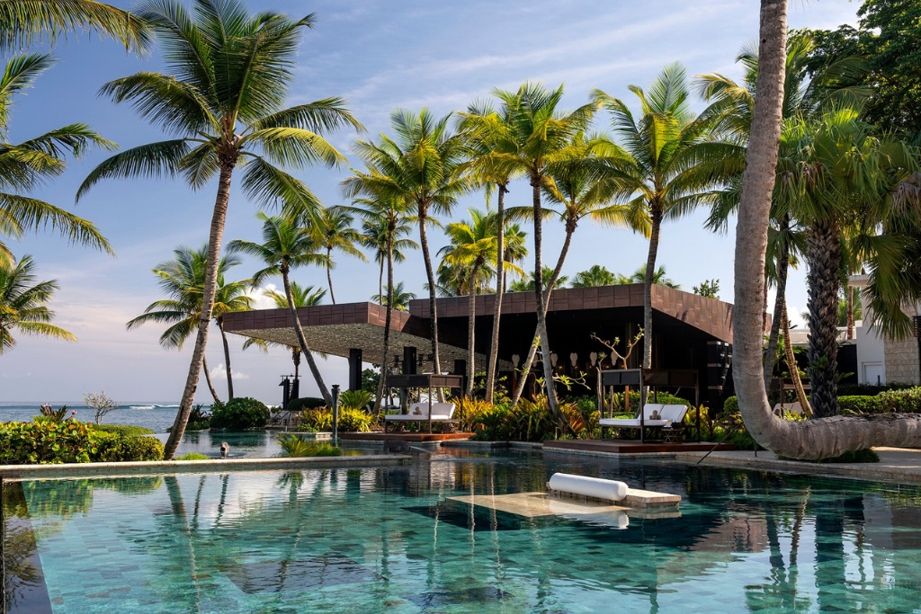 pool with lounge chairs and in pool chairs at historic hotel dorado beach
