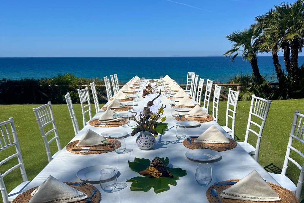 long lunch table by the sea at datu wellness, palazzo belmonte, italy